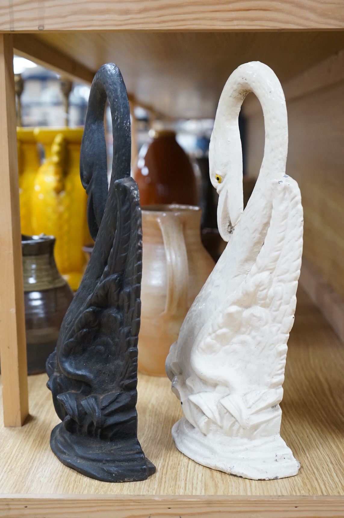 Two Victorian cast iron ‘swan’ door stops, one painted, 38cm